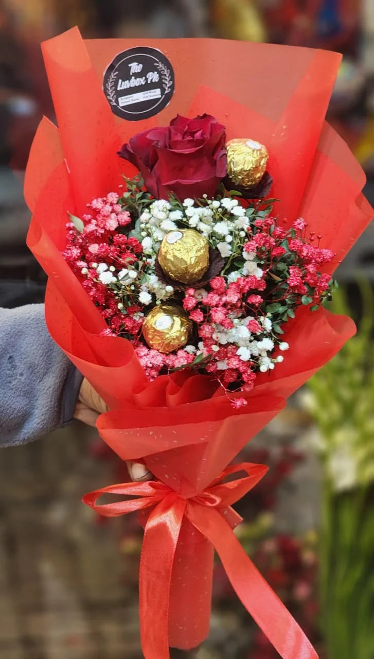 Romantic mini bouquet with one fresh rose, three Ferrero Rocher chocolates and baby's breath flowers for delivery in Pakistan