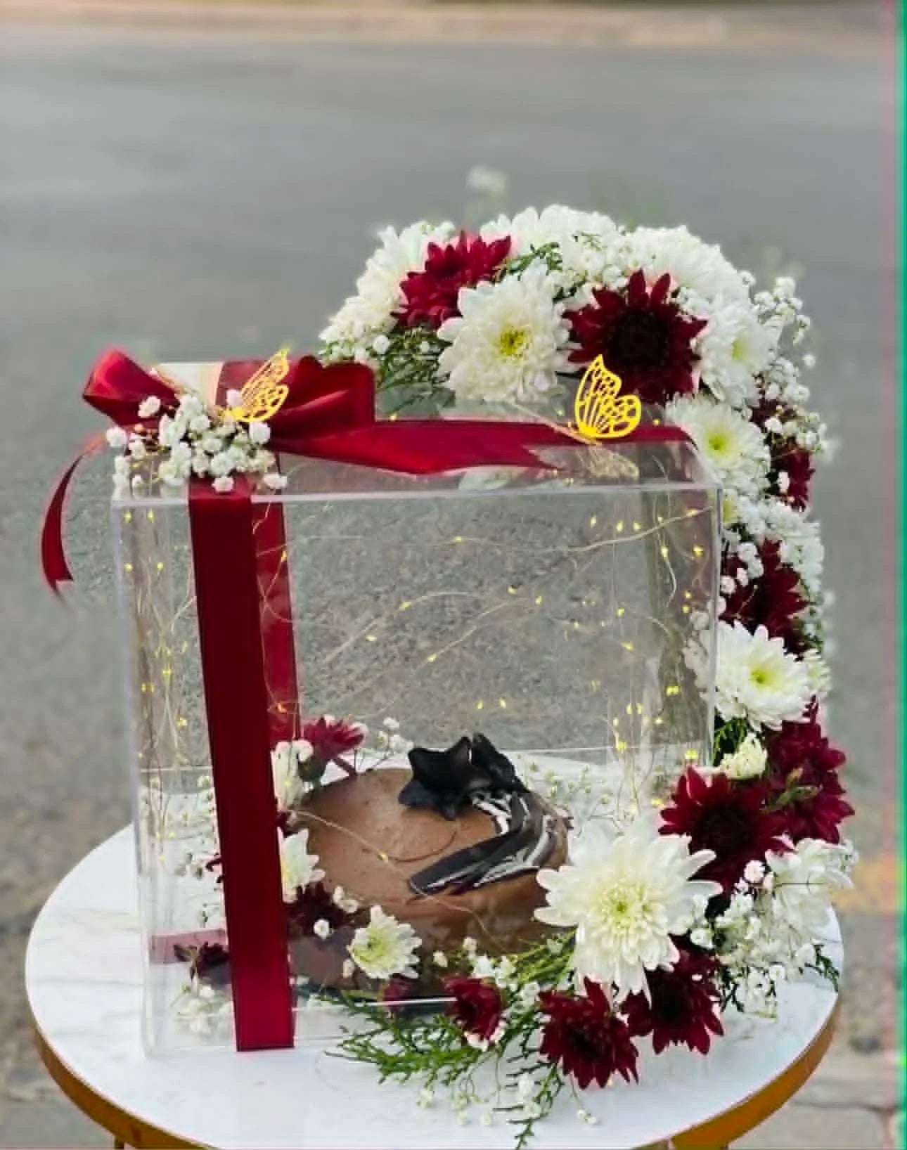 Luxury acrylic box with 2 lbs cake and full floral arch design for premium birthday gifting in Islamabad.