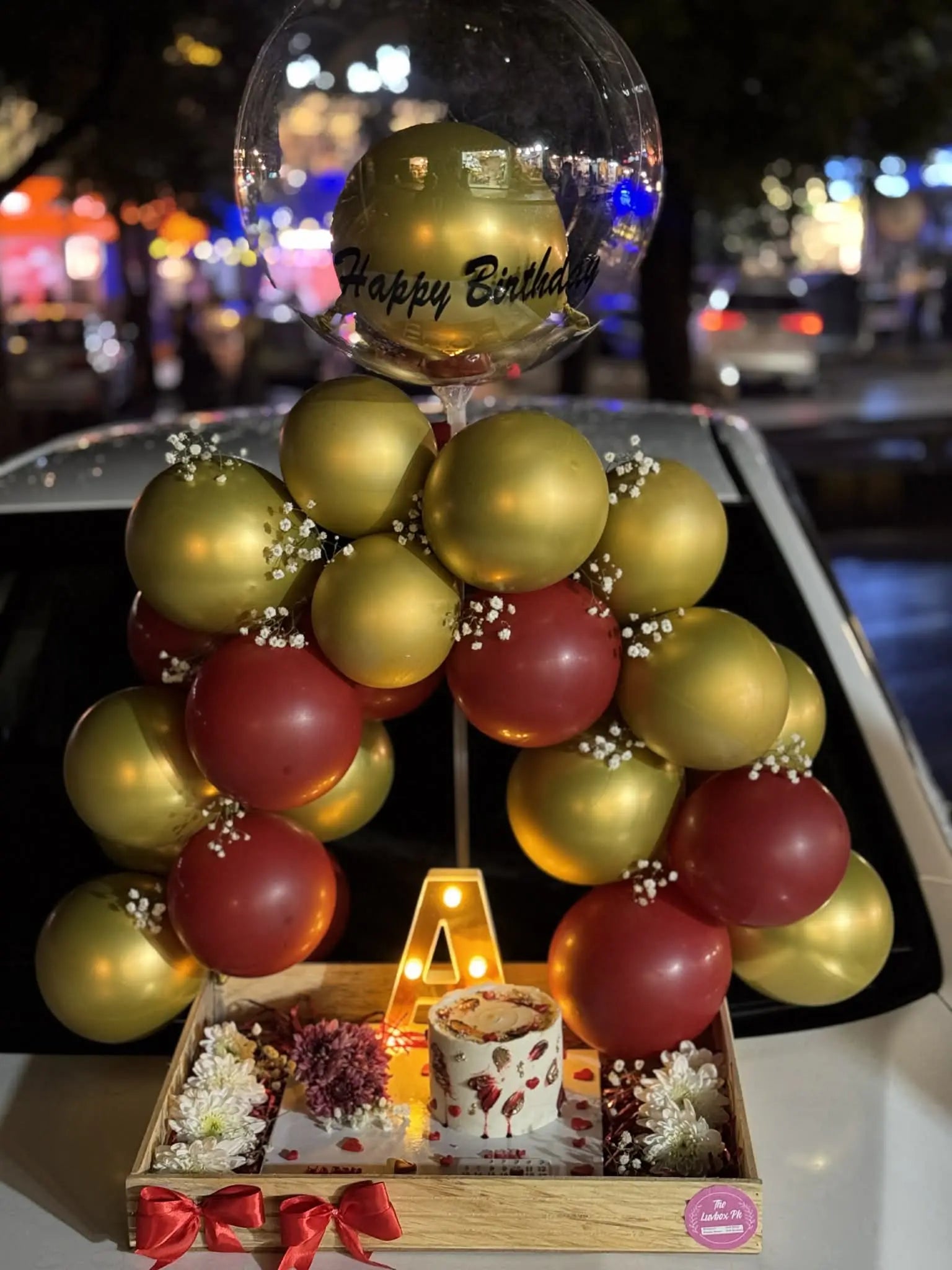Luxury balloon arch wooden tray with LED lights, cake tray, LED letter and custom name balloon for celebrations in Islamabad.