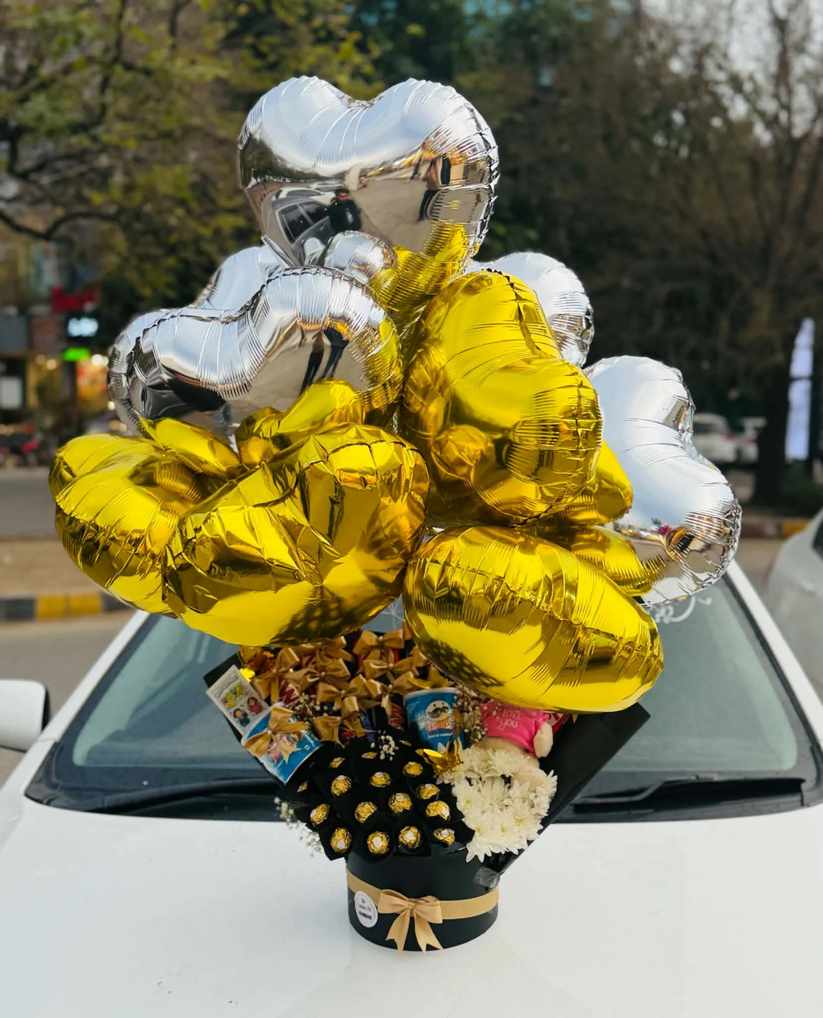 Luxury birthday box with white chrysanthemums premium chocolates mini teddy and 15 foil balloons in Pakistan