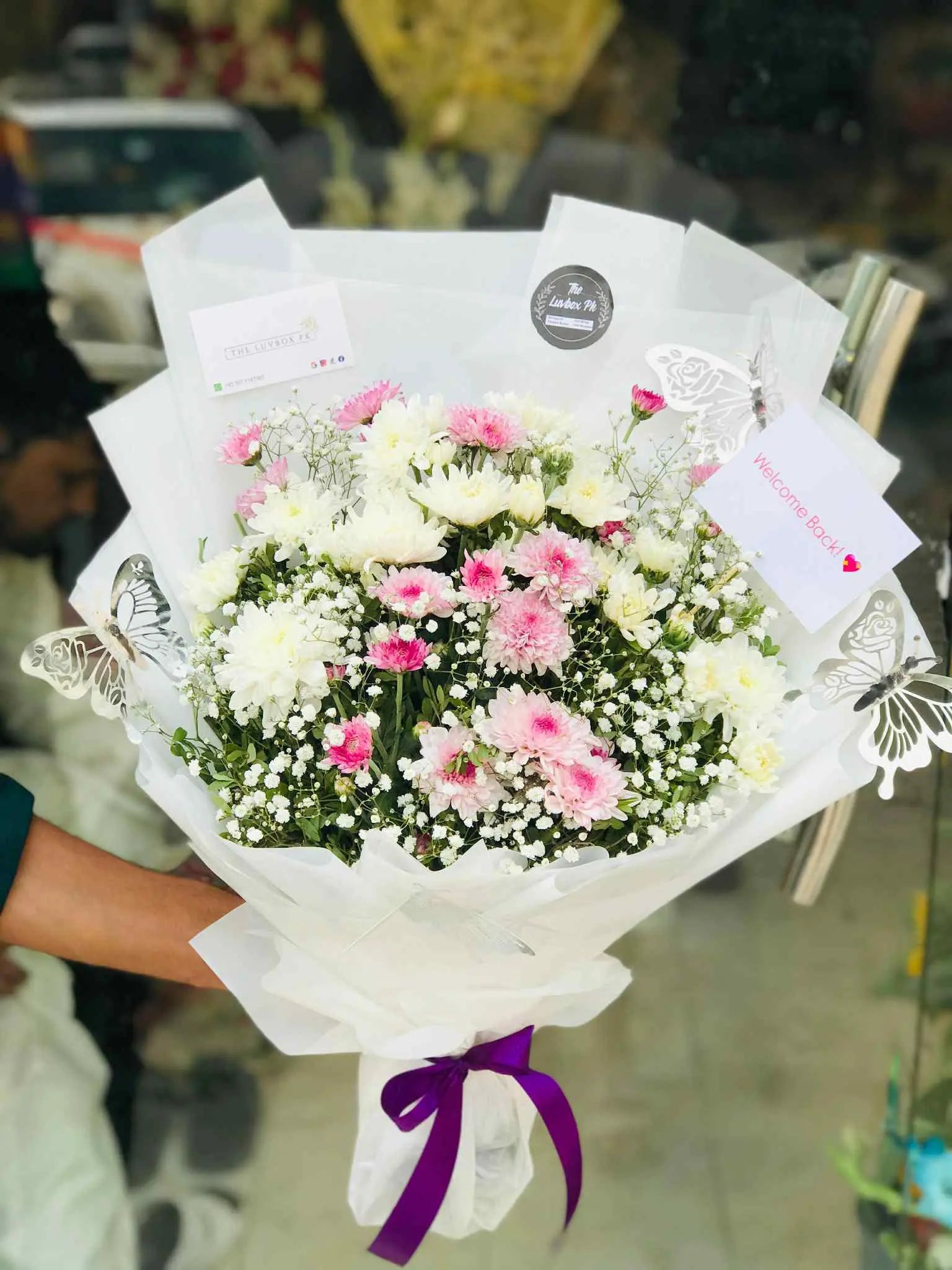 Mixed pink and white chrysanthemum bouquet beautifully wrapped