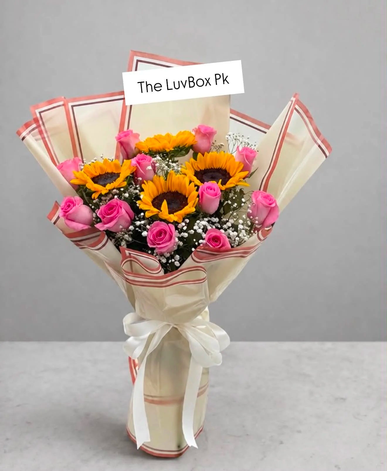 Beautiful flower bouquet with fresh pink roses and bright sunflowers, elegantly arranged for birthdays, anniversaries and flower delivery in Islamabad.