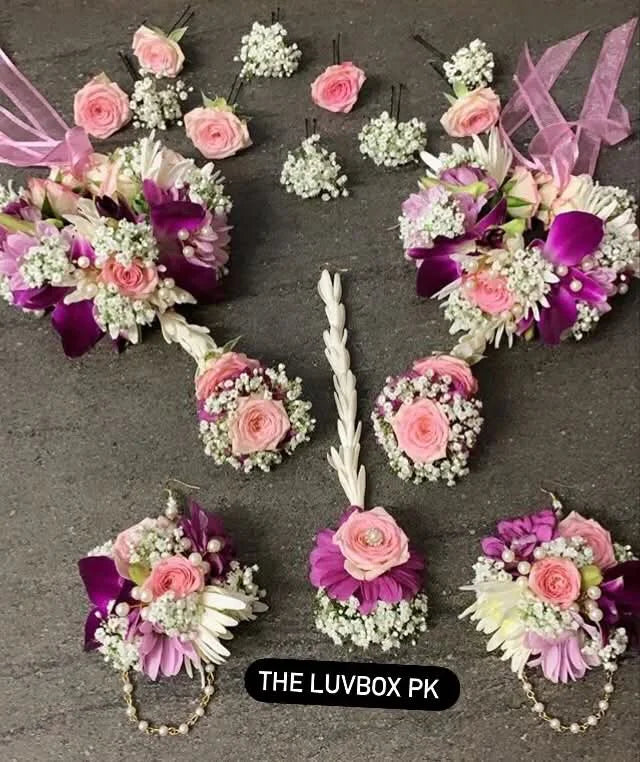 Premium pink bridal floral jewelry set with heavy gajras, hair floral pins, bindiya, and floral earrings for Mehndi, Nikah, and wedding events.