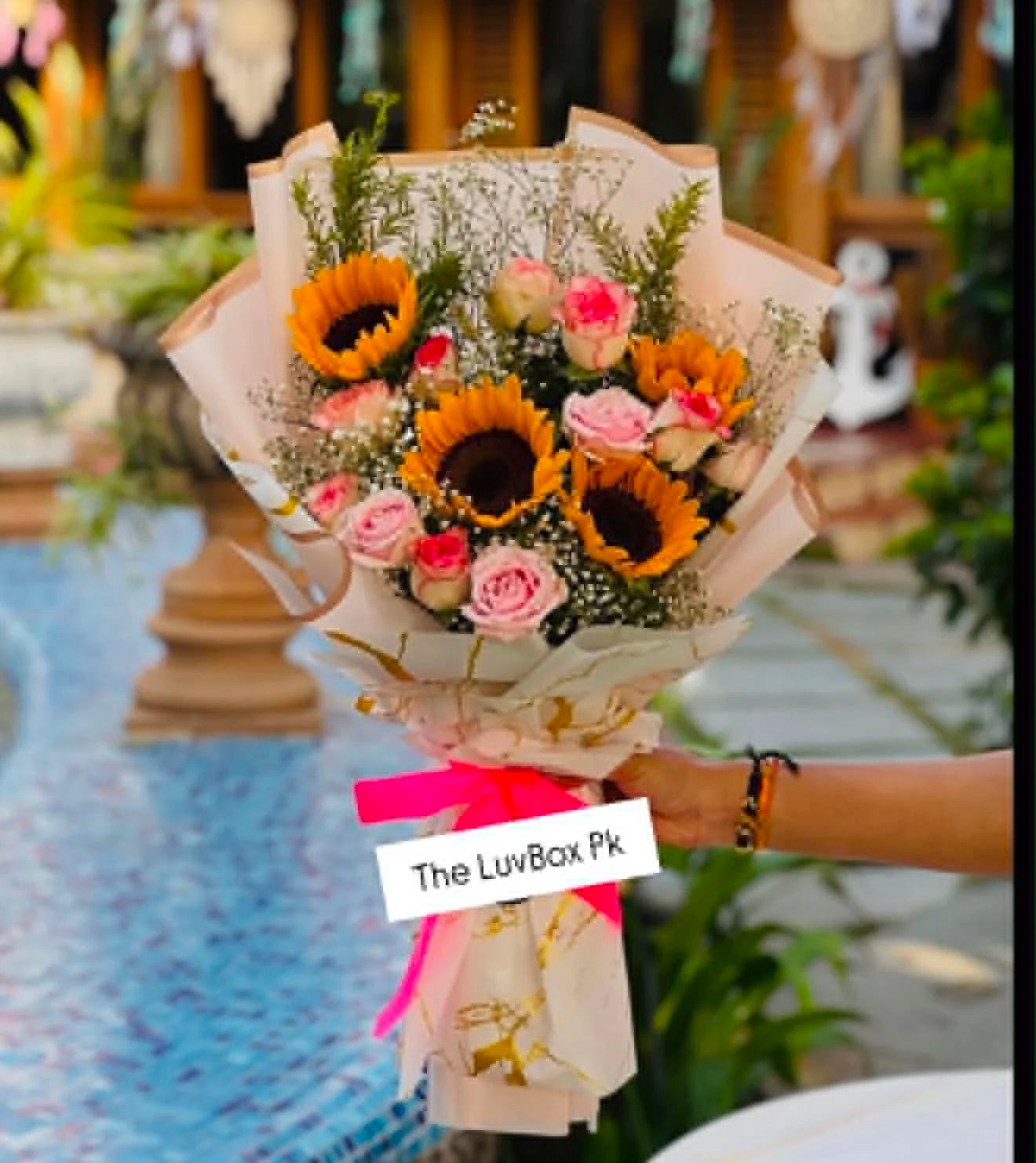 Gorgeous sunflower bouquet with pink roses, beautifully wrapped for birthdays, anniversaries, romantic surprises, and flower delivery in Islamabad.