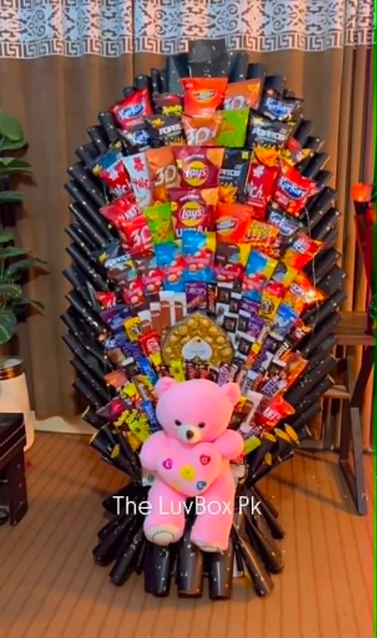 Largest oversized chocolate and snack bouquet with assorted chocolates, candies, snacks and a teddy bear at the bottom, perfect for luxury gifts in Islamabad Pakistan.