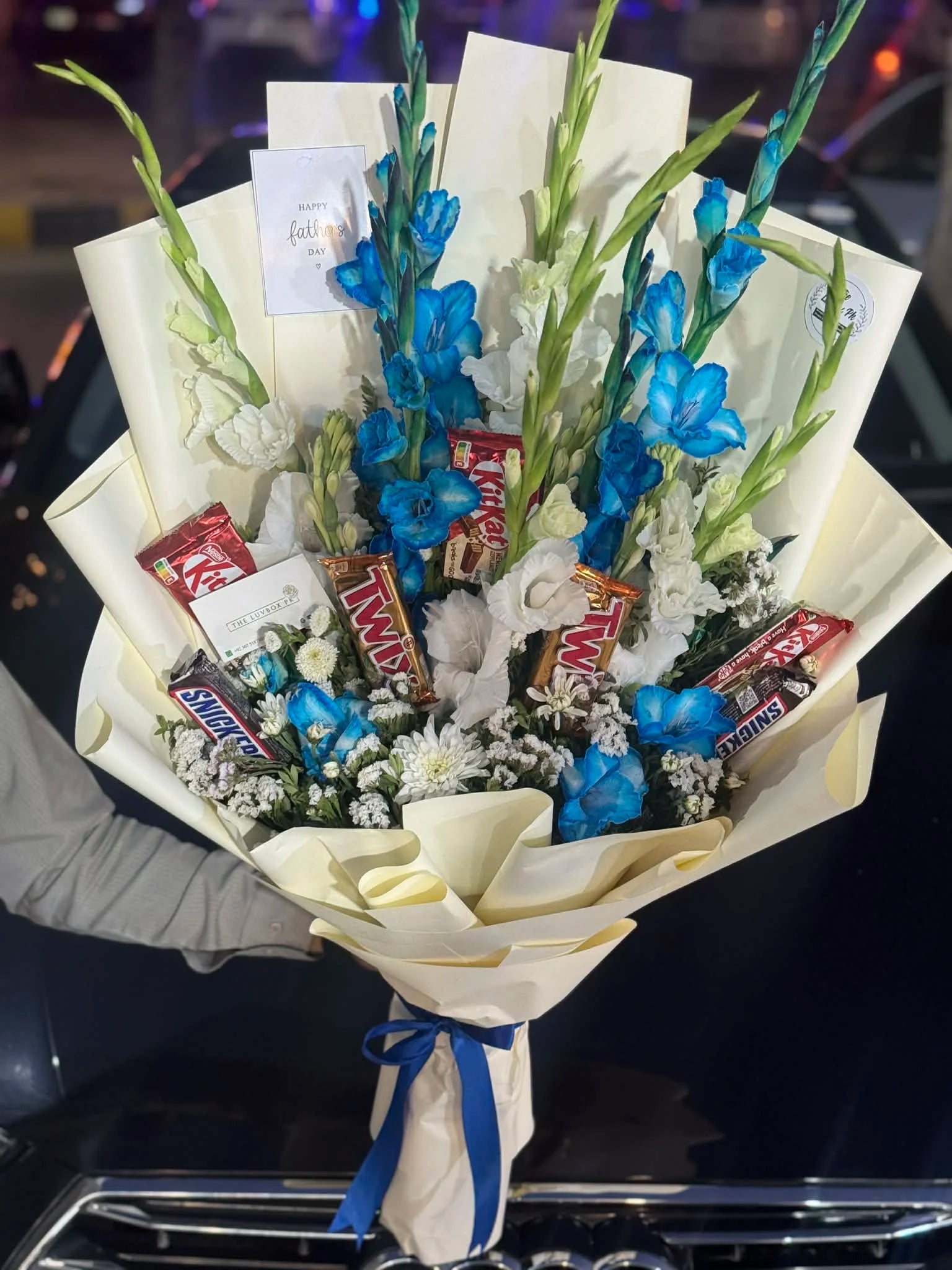 Eid flower bouquet with blue and white gladiolus and mixed chocolates