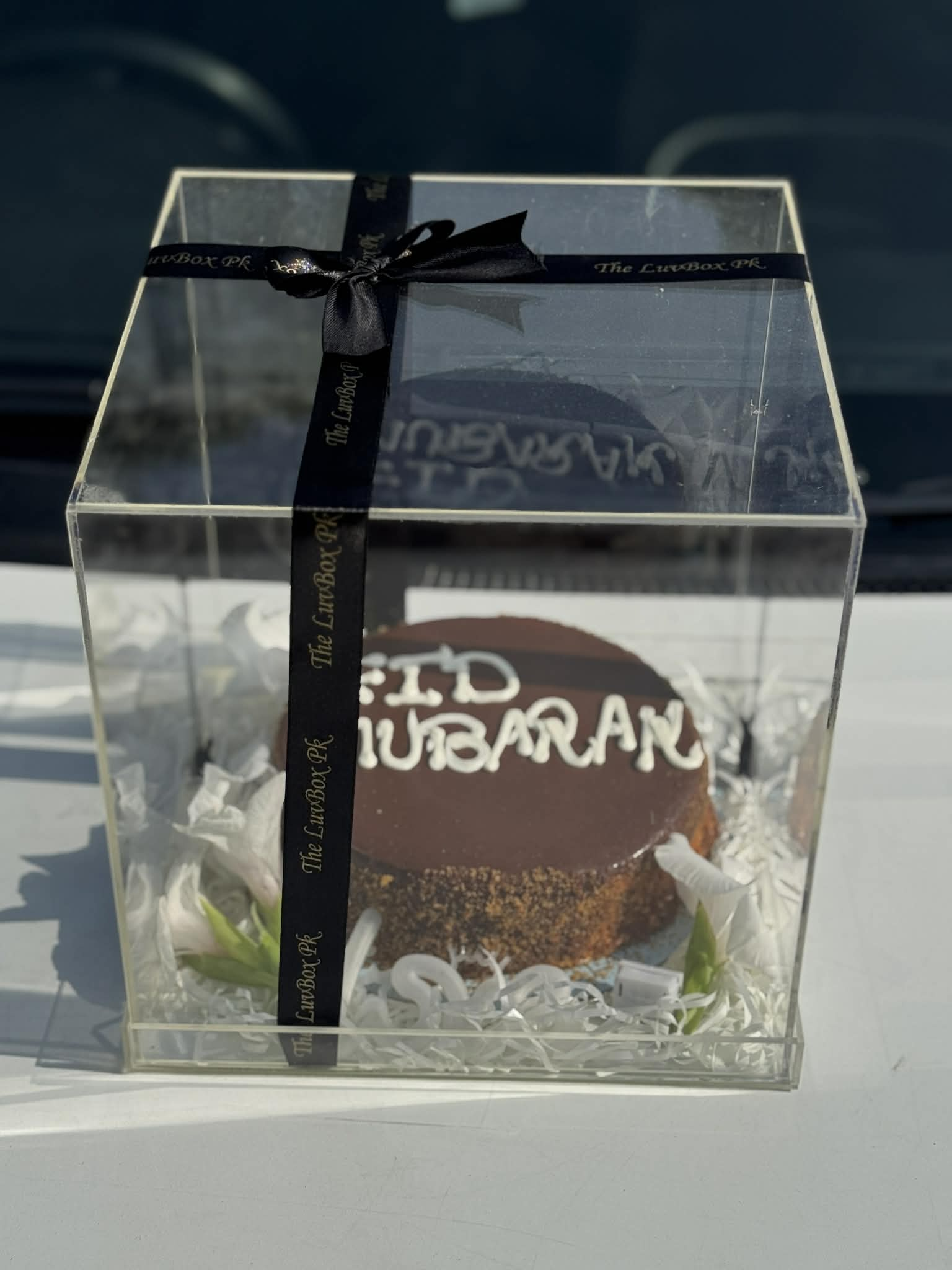 Luxury Eid Mubarak cake in acrylic box with minimal flower decoration