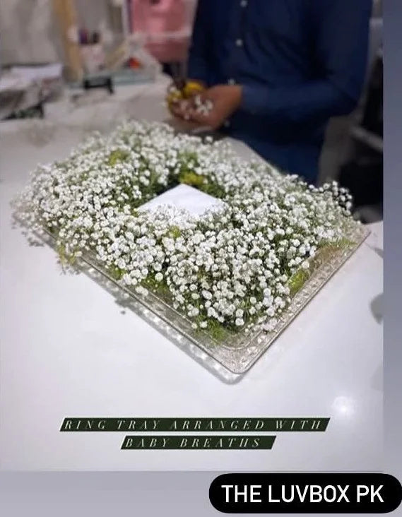 Premium acrylic wedding ring tray decorated with Baby’s Breath flowers and center ring holder space for engagement and Nikah ceremonies in Pakistan.