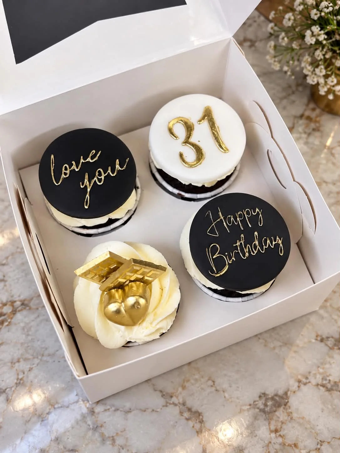 Customized birthday cupcake gift box featuring four beautifully decorated birthday-themed cupcakes for delivery in Pakistan