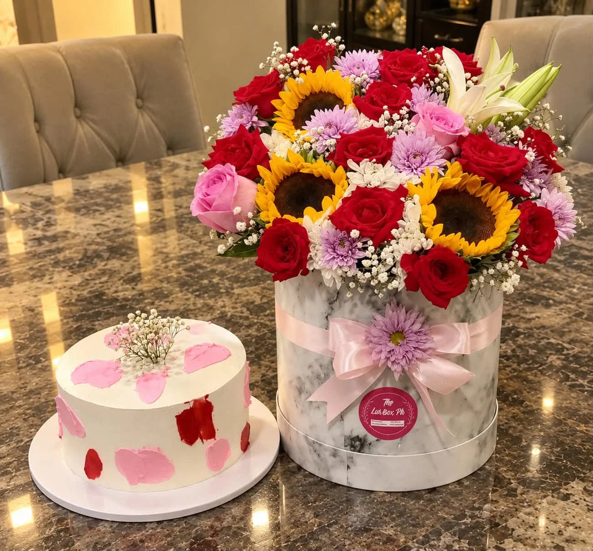 Luxury anniversary flower box with fresh roses lilies and sunflowers paired with 2 lbs chocolate fudge cake for delivery in Pakistan
