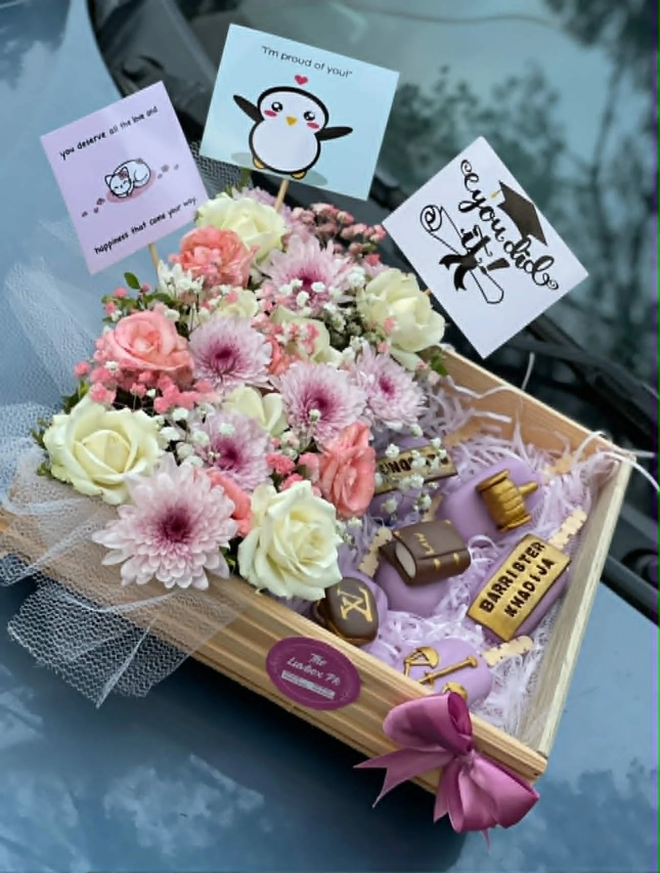 Graduation themed wooden basket with flowers and cakesicles for convocation gift delivery in Islamabad.
