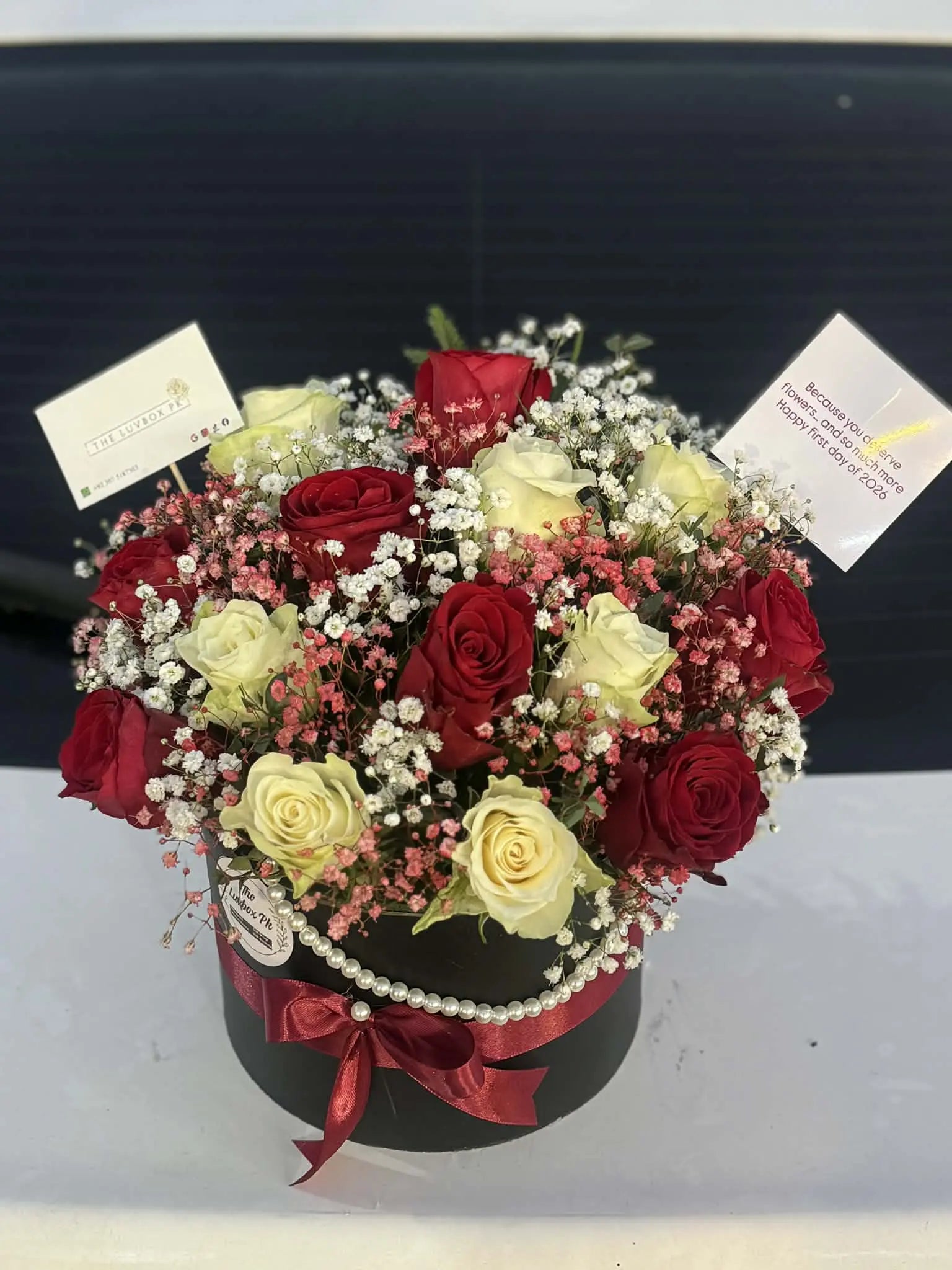 Happy New Year flower box with premium red and white roses.