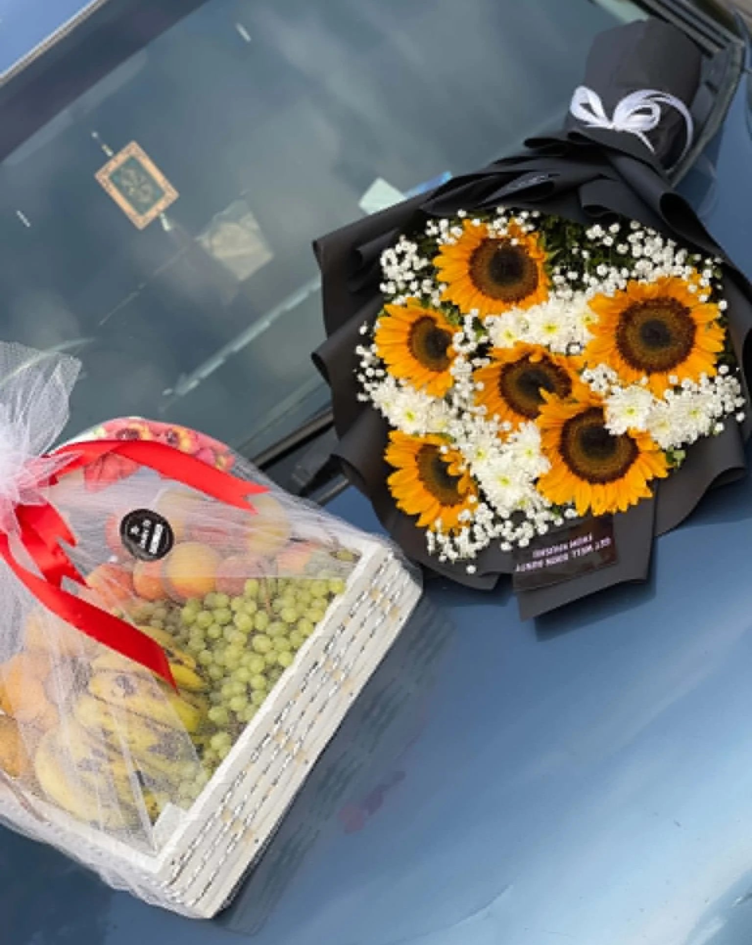 Get well soon gift basket with 3 to 4 kg seasonal fruits, sunflower and white chrysanthemum flowers, beautifully arranged for delivery in Pakistan.