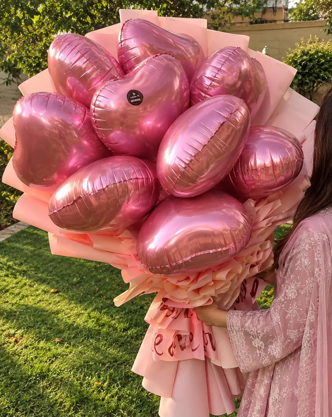 Romantic bouquet of nine heart-shaped balloons beautifully wrapped for anniversary and birthday gift delivery in Pakistan