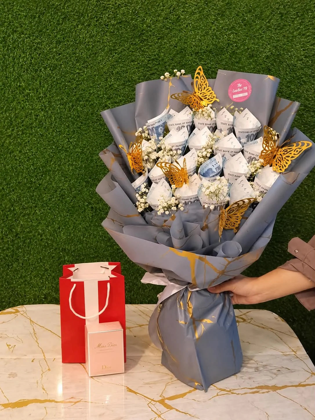 Luxury birthday gift for wife featuring PKR 20,000 money bouquet made with twenty 1000 rupee notes and Wasim Akram 302 perfume for women
