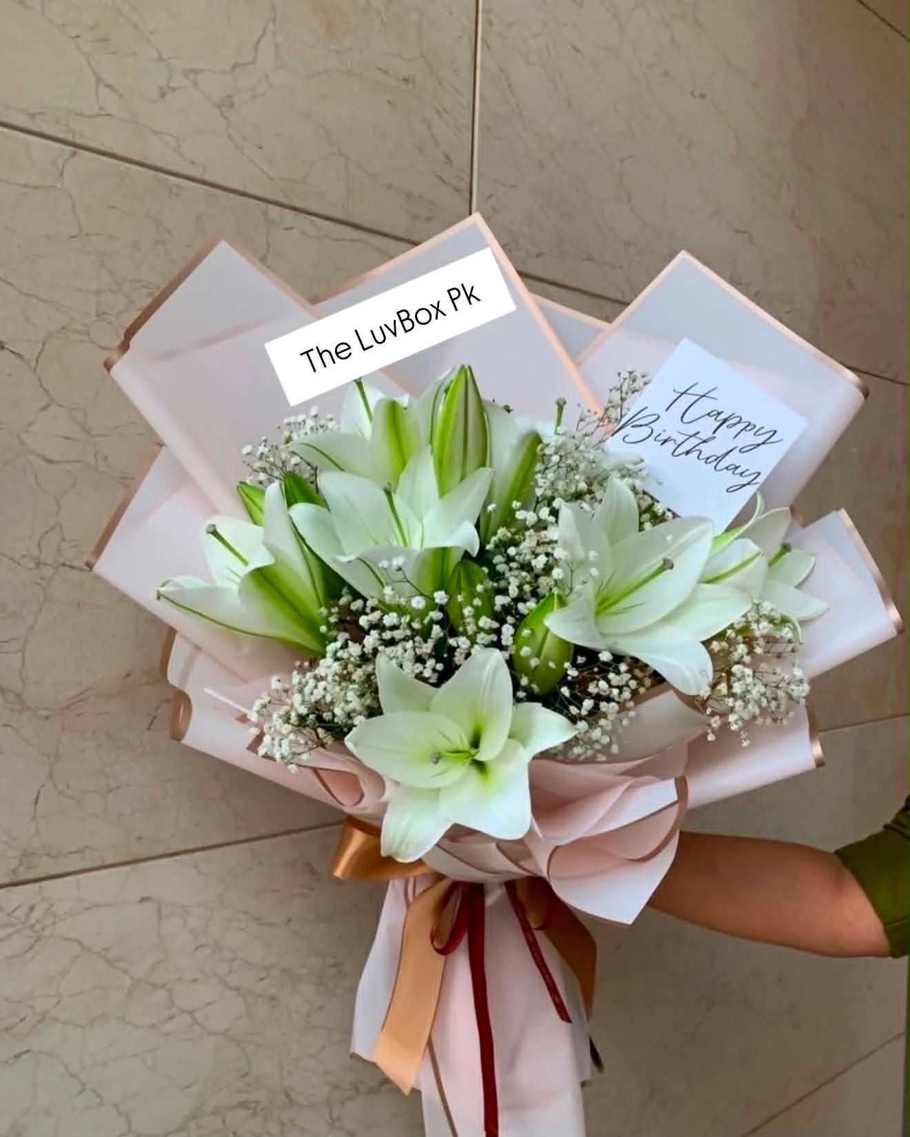Elegant white lily bouquet beautifully arranged in an all-white theme, perfect for birthdays, anniversaries, weddings, and flower delivery in Islamabad.