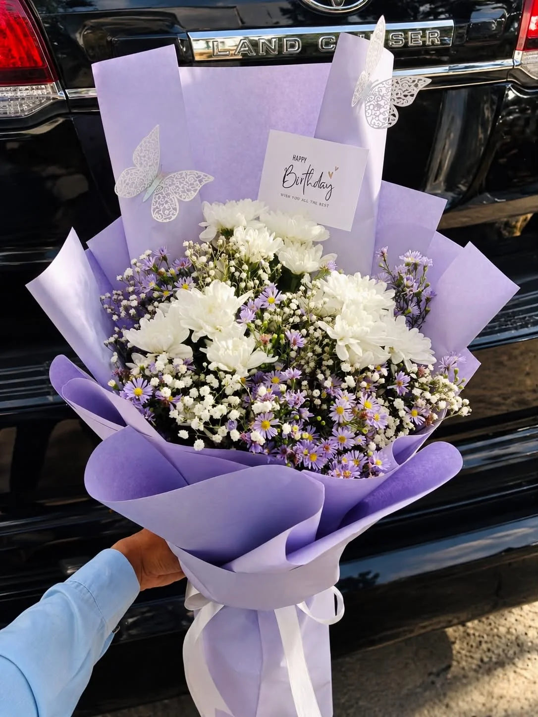 Elegant white flower bouquet with lavender purple wrapping for birthday and anniversary flower delivery in Islamabad and Pakistan