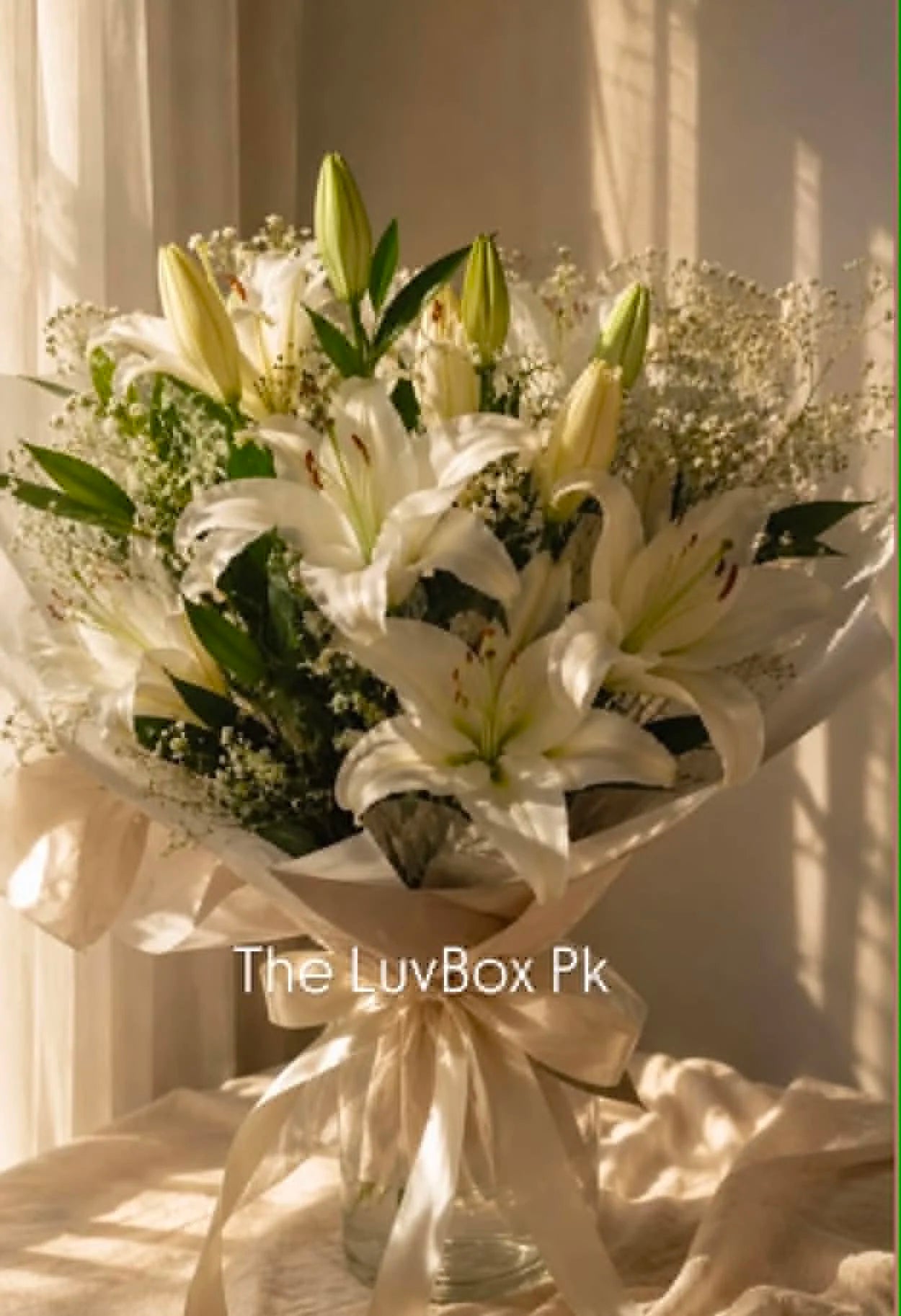Oversized luxury white lily bouquet elegantly wrapped in white, creating a sophisticated all-white floral arrangement for delivery in Islamabad.