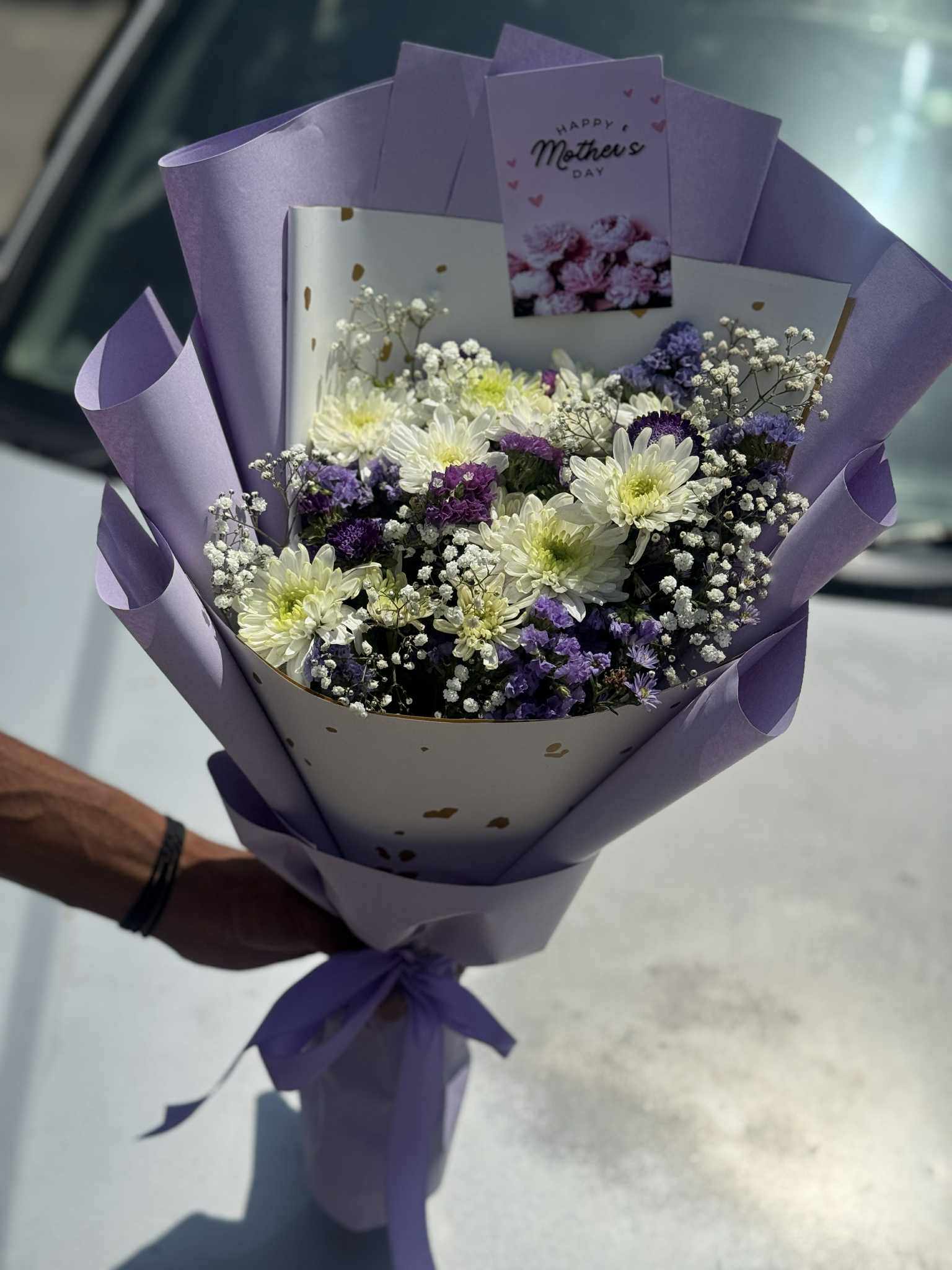 Moonlight Charm bouquet with white flowers wrapped in purple paper for elegant gifting