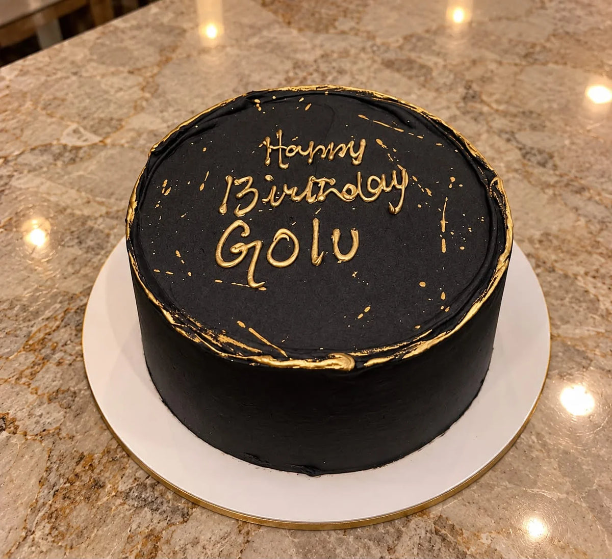 Premium 2 lbs black and gold customized birthday cake for him with elegant golden decorations and cake delivery in Pakistan