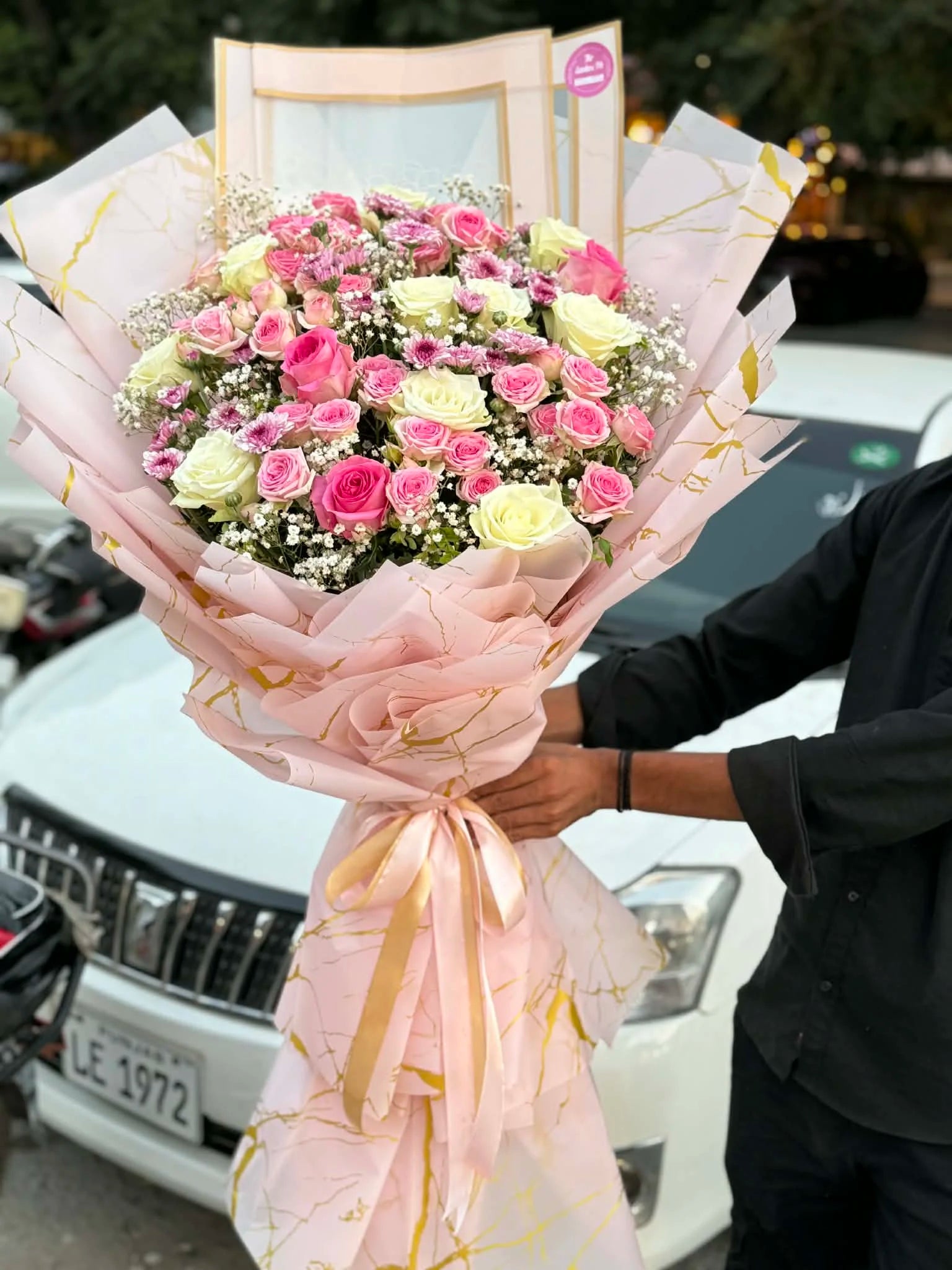 Oversized pink and white rose bouquet with spray roses and babys breath