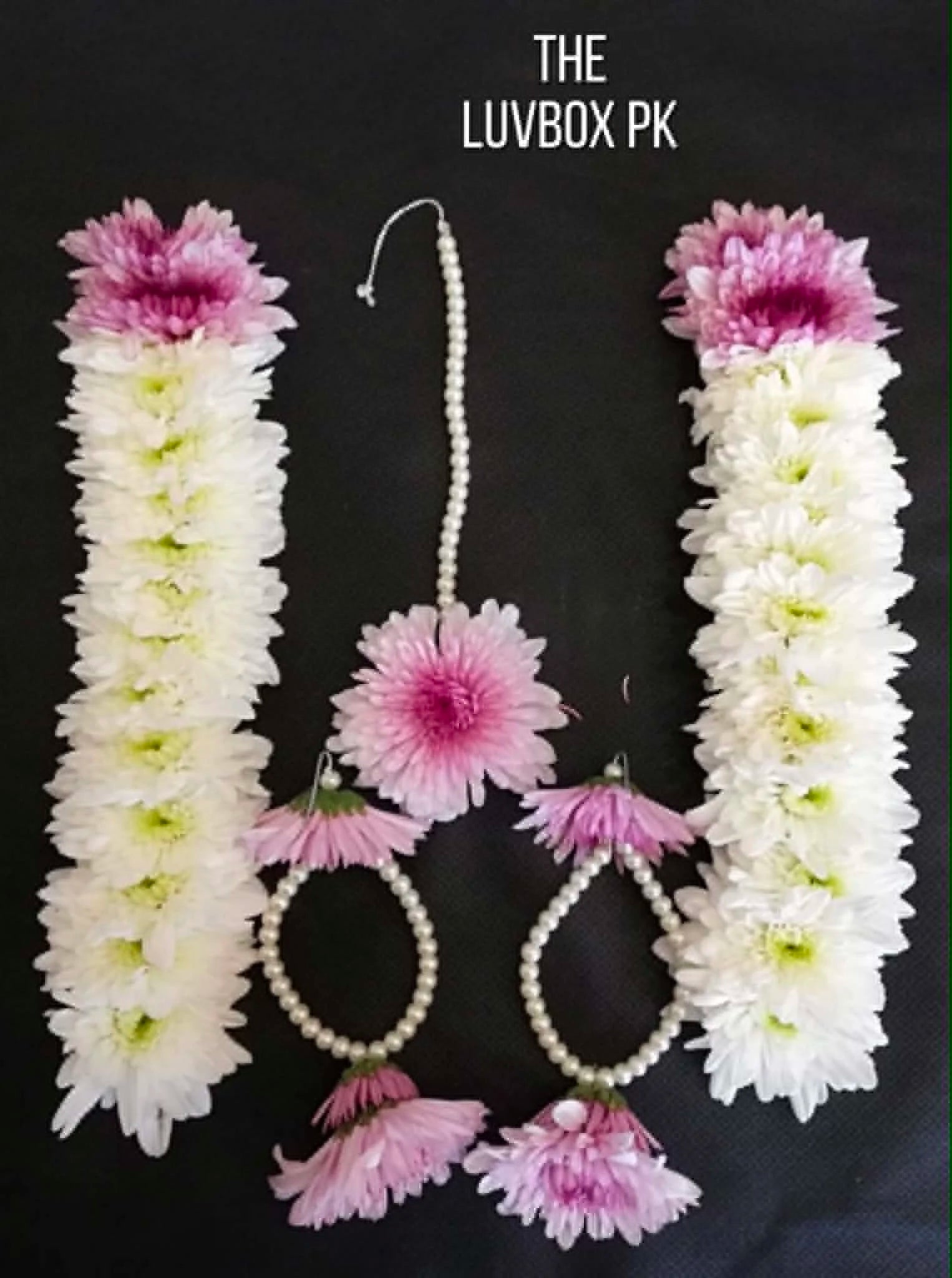Elegant white floral gajra with pink chrysanthemums, matching floral earrings and bindiya for bridal, Mehndi, and wedding celebrations in Pakistan.