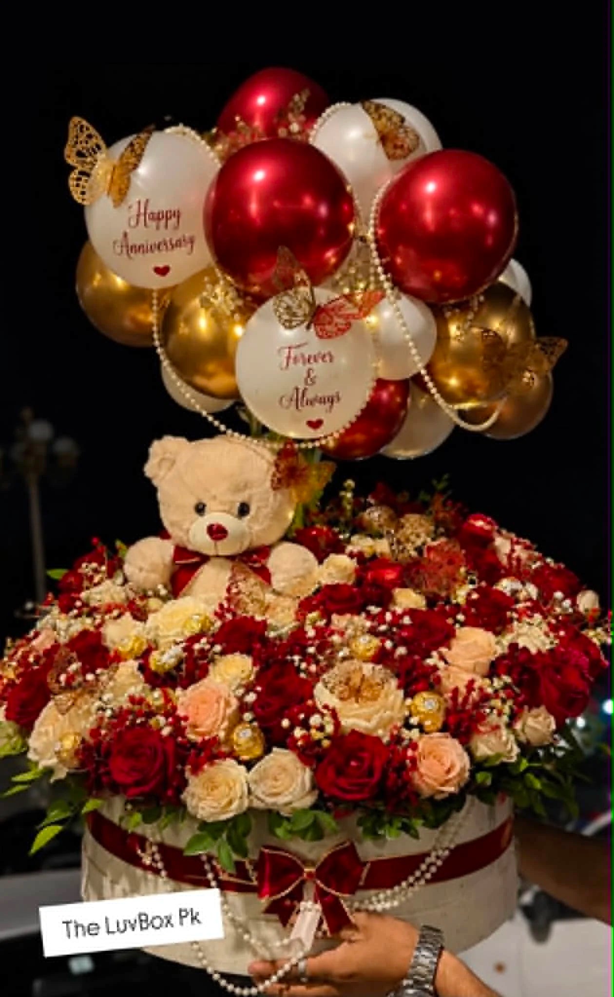 Luxury giant round flower box filled with roses, pearl decorations, balloon arch and teddy bear, designed as a special anniversary gift for her in Islamabad.