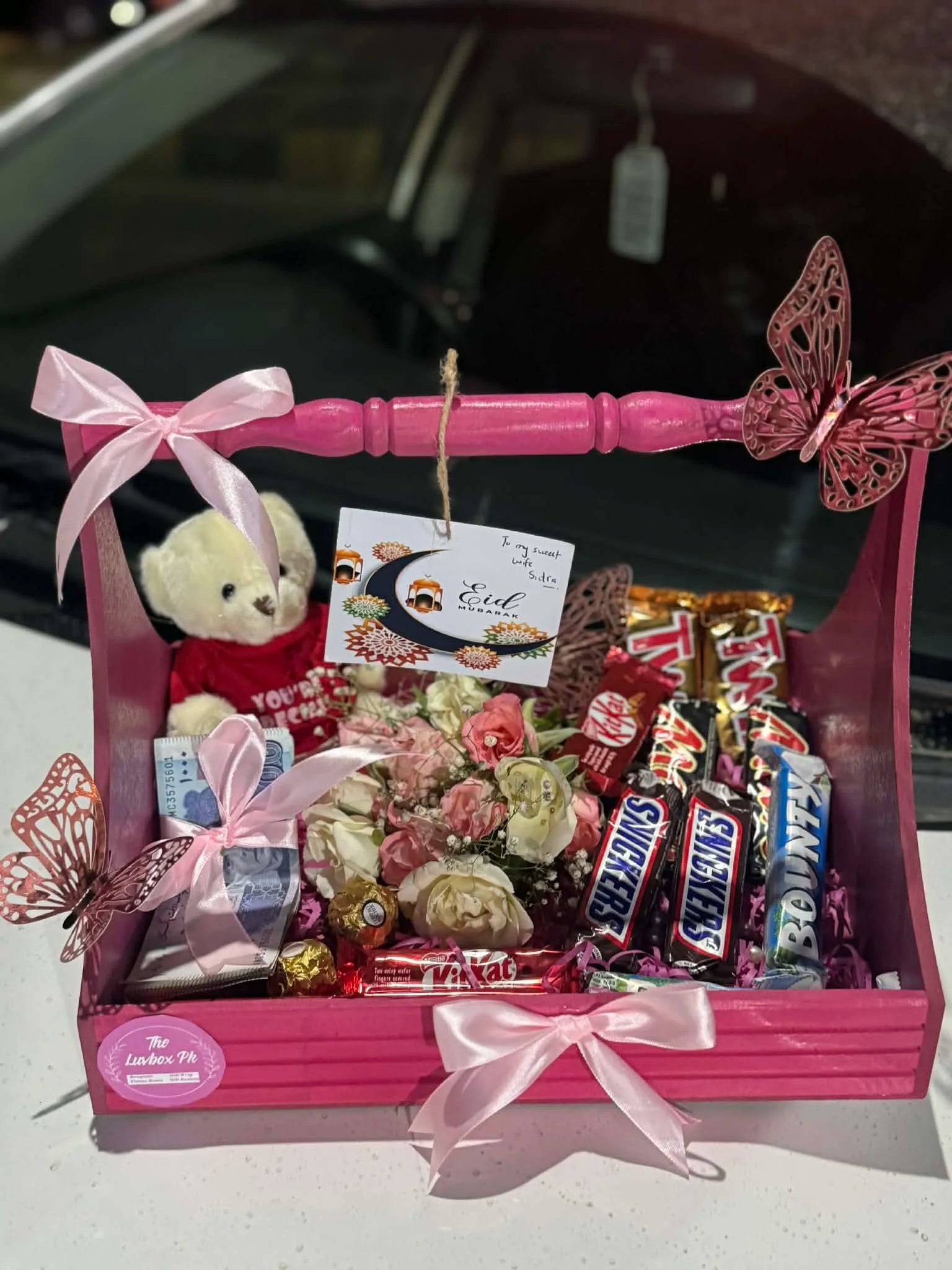 Pink Eid wooden basket with chocolates flowers and 5000 rupees eidi gift