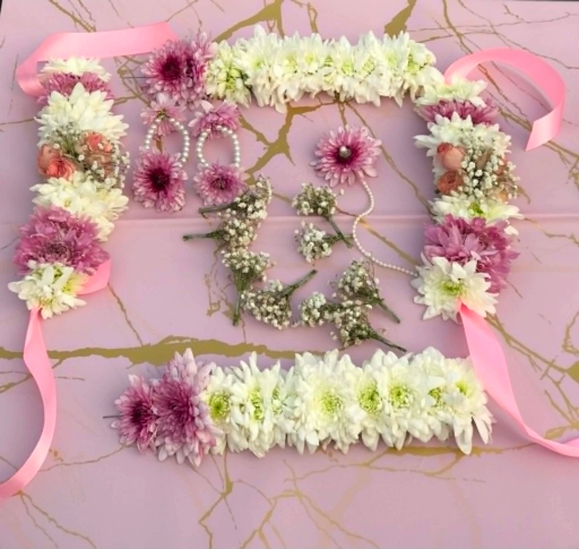 Luxury pink bridal floral jewelry set with heavy gajras, floral hair pins, bindiya, and floral earrings for Mehndi, Nikah, and wedding events in Pakistan.