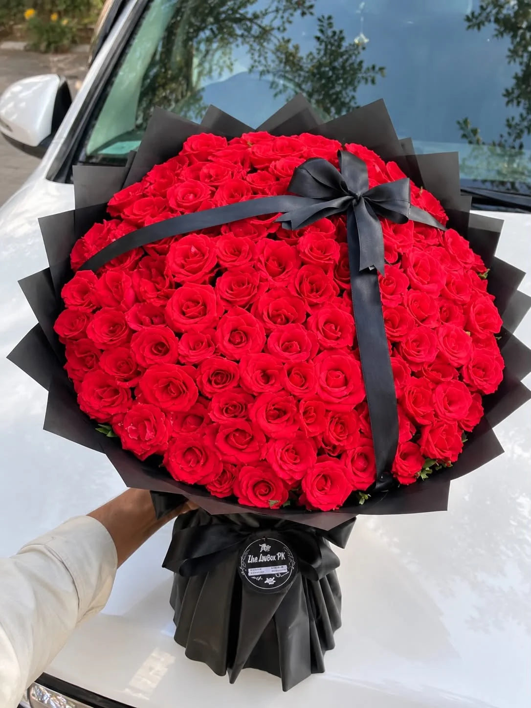 Luxury oversized bouquet of 100 fresh red roses with elegant wrapping for romantic flower delivery in Islamabad and Pakistan