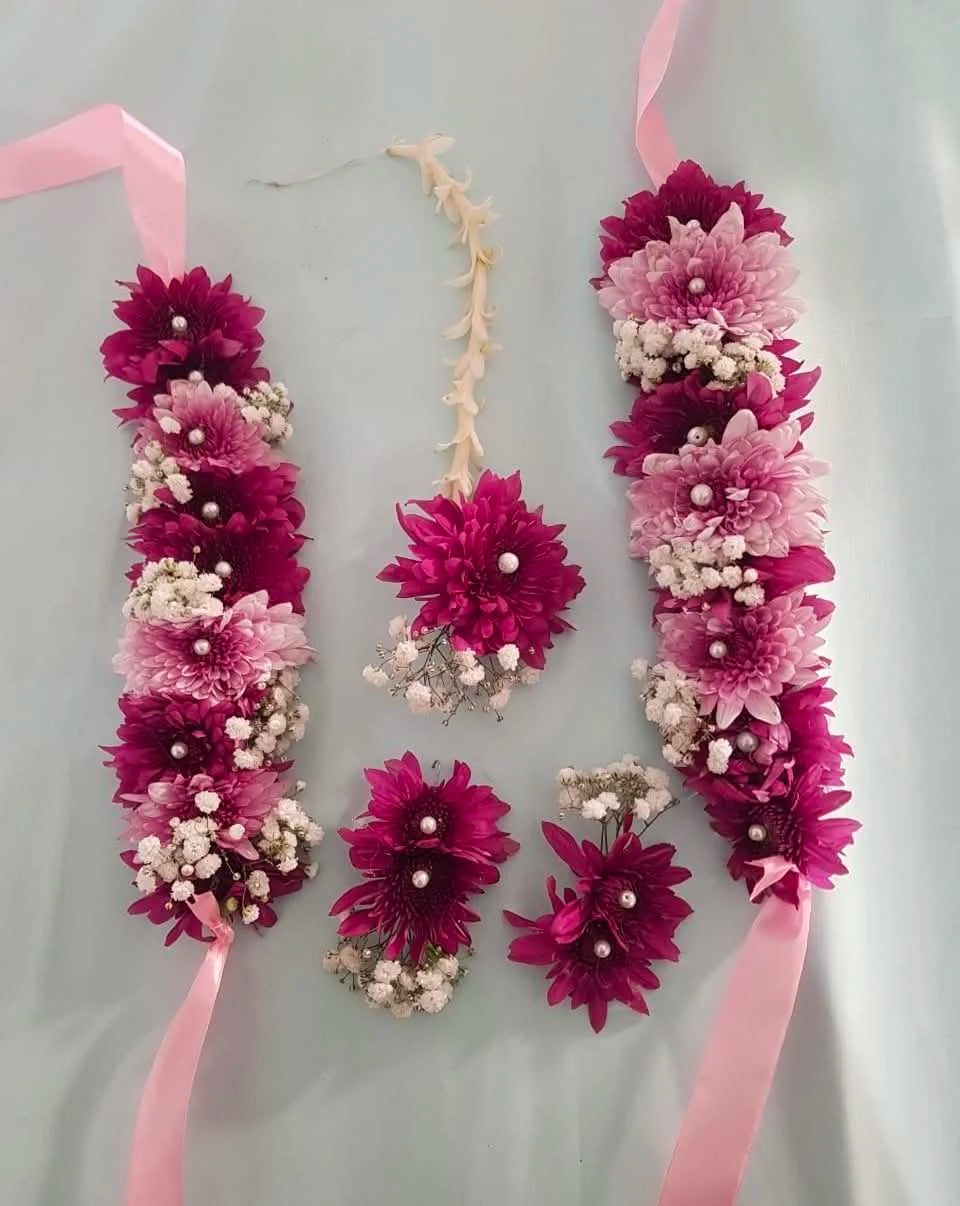 Best selling bridal floral jewelry set with pink and purple chrysanthemum gajras, floral earrings, and bindiya for weddings in Pakistan.