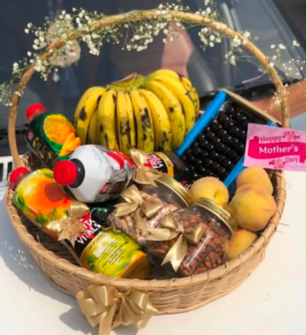 Luxury fruit basket with 3 to 4 kg mixed seasonal fruits, large juice bottles, and two dry fruit boxes for premium gift delivery in Pakistan.