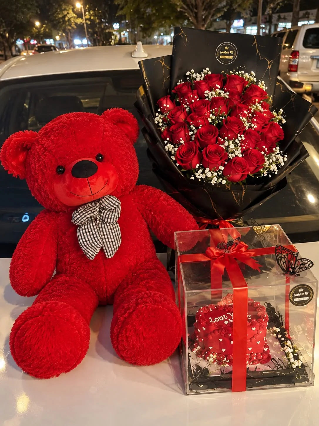 Romantic anniversary gift with 3 feet red teddy red rose bouquet and 3 lbs heart-shaped cake in acrylic box Pakistan