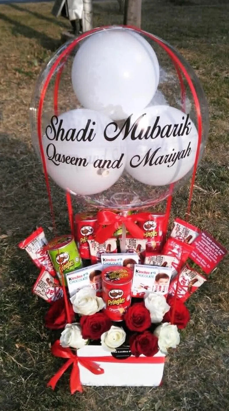 Shaadi Mubarak wedding gift balloon box with custom message, mixed chocolates, and fresh flowers for wedding congratulations in Pakistan.