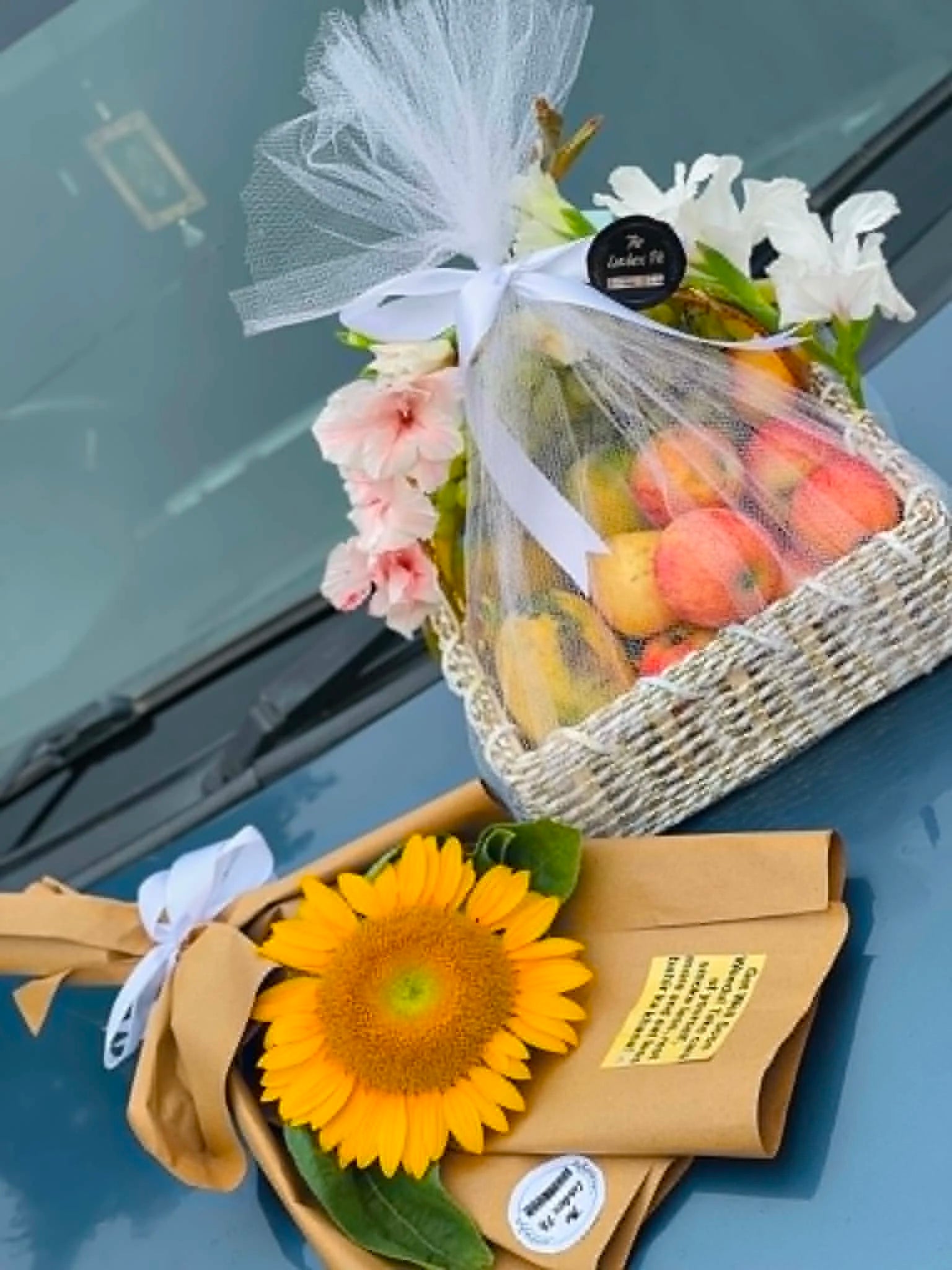 Cute get well soon gift basket with 2 to 3 kg seasonal fruits, sunflower, flowers, and beautiful net wrapping for gift delivery in Pakistan.
