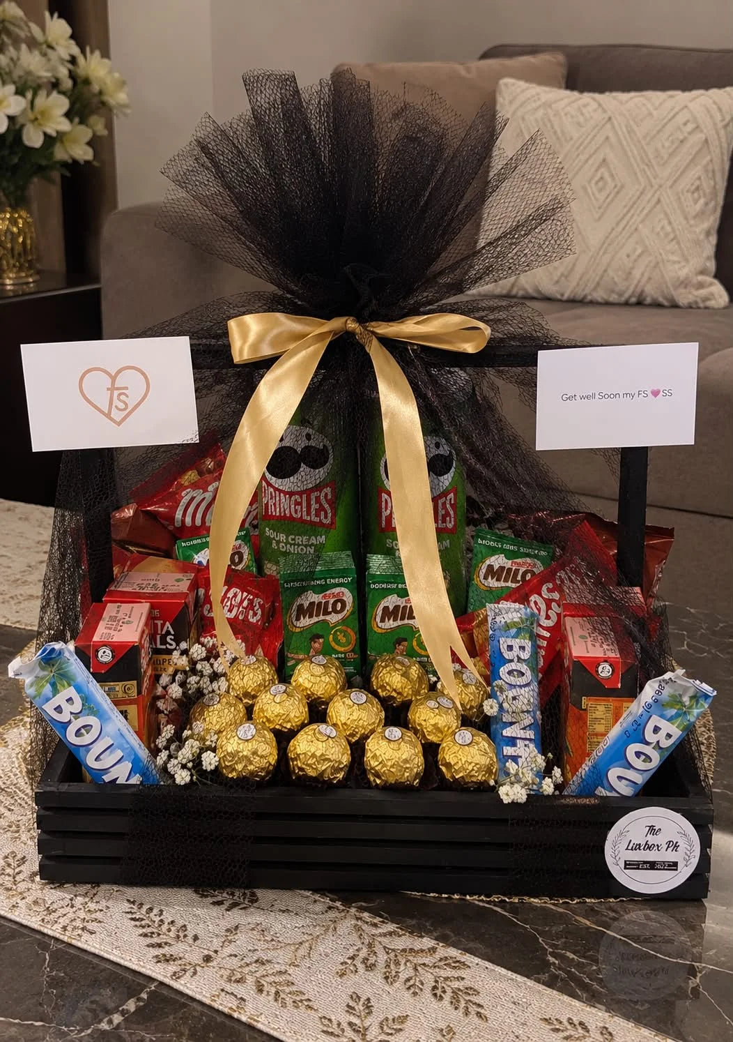 Get Well Soon gift tray with mixed premium chocolates Pringles and elegant black net wrapping in Pakistan
