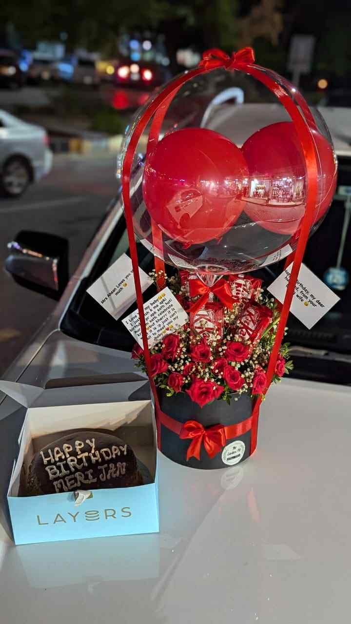 Affordable combo with balloon surprise box, fresh red roses, KitKat chocolates, and layered cake – perfect gift for birthdays and surprises.