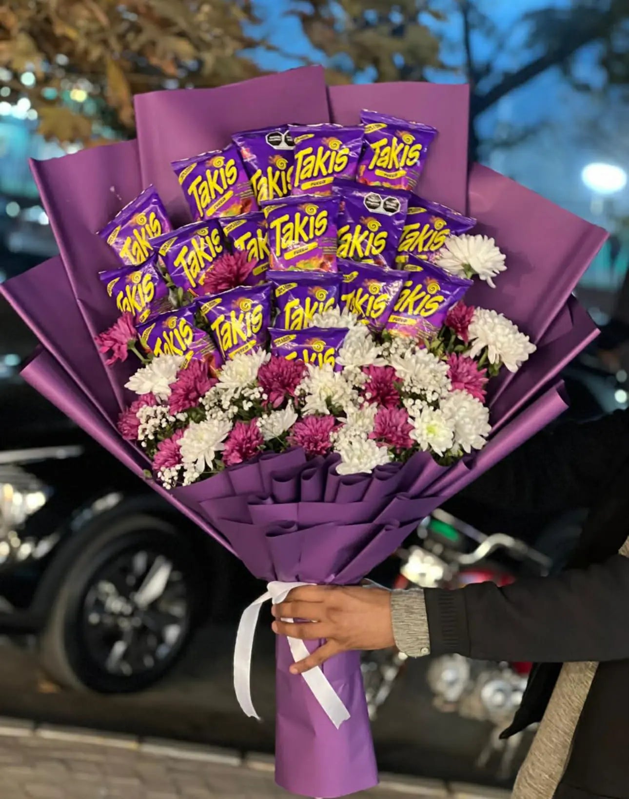 Takis snack bouquet mixed with fresh flowers for gifting.