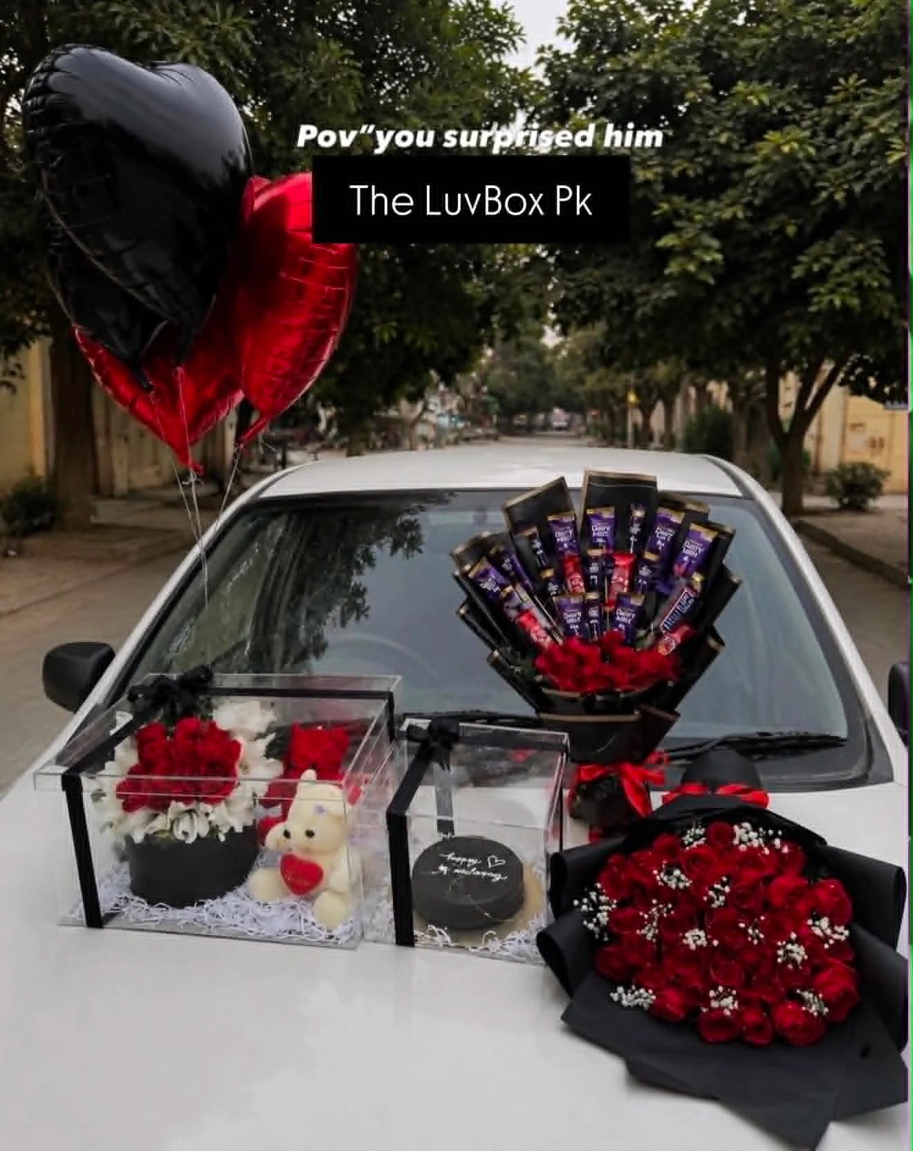Luxury gift combo for him with red rose bouquet, Dairy Milk chocolate and rose bouquet, black and gold 2 lbs cake in acrylic box, teddy bears and flower box.