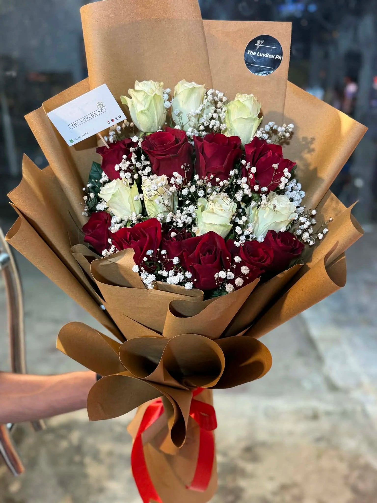 Ultra luxury long stem red and white roses bouquet with elegant brown wrapping Islamabad