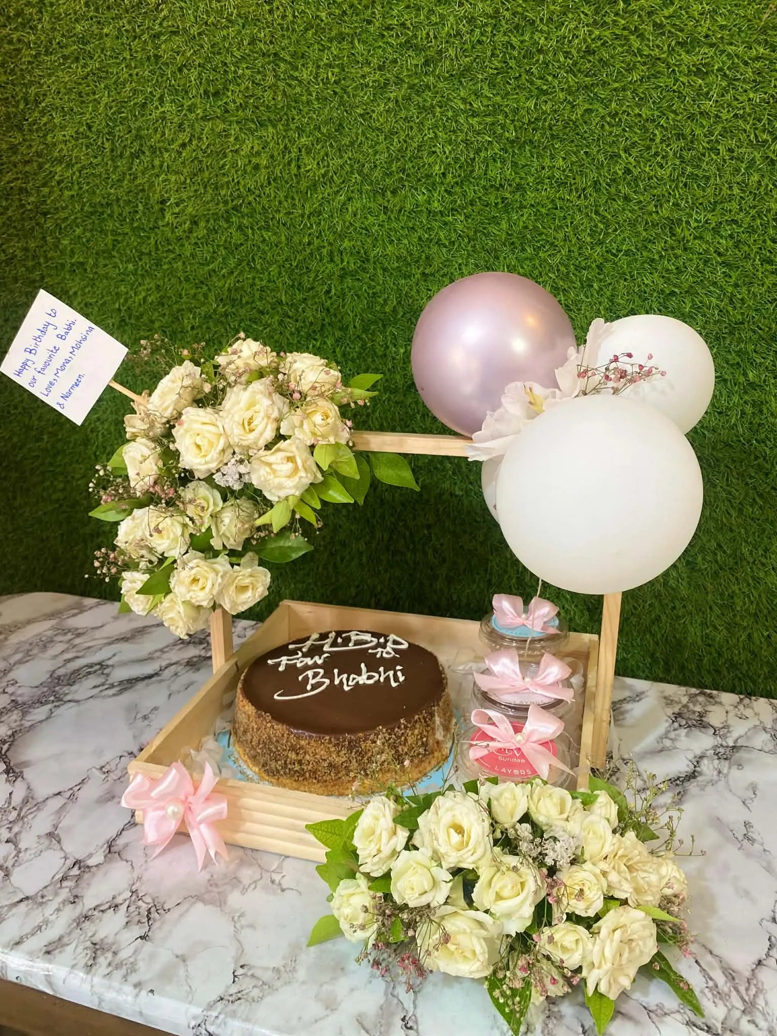 Gorgeous wooden tray with cake, sundaes, roses on handle and balloons for gift delivery in Islamabad.