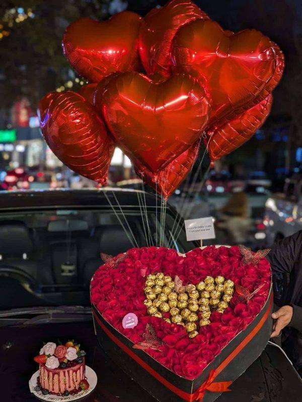 XXL heart-shaped red rose box with Ferrero Rocher chocolates, custom cake and helium balloons from The LuvBox PK