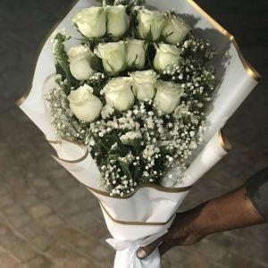 Elegant white rose bouquet wrapped beautifully for him – The LuvBox Pk Islamabad.