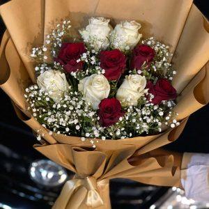 Elegant red and white rose bouquet in brown wrap – The LuvBox Pk, flower delivery in Islamabad.