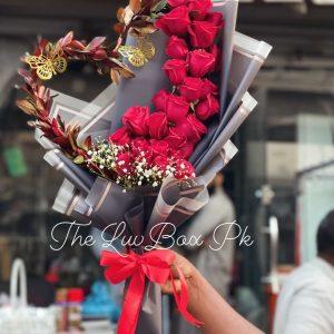 Heart-shaped bouquet with red roses and petals – romantic gift by The LuvBox Pk, gift shop in Islamabad.