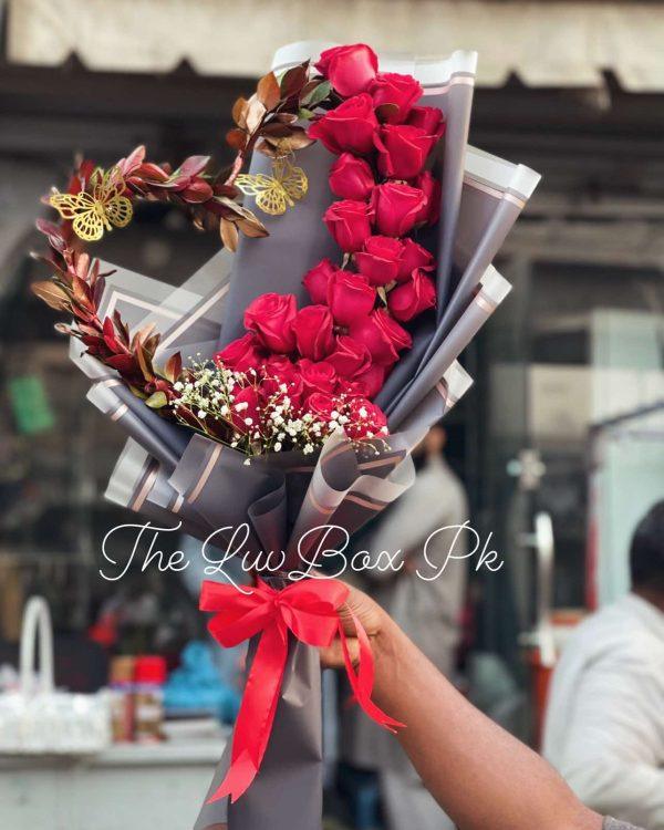 Heart-shaped bouquet with red roses and petals – romantic gift by The LuvBox Pk, gift shop in Islamabad.