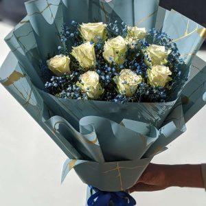 White roses bouquet in blue wrap – premium floral gift for him by The LuvBox Pk, flower shop in Islamabad.