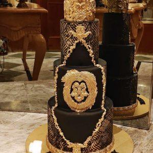 Royal 3-tier luxury black and gold cake with crown – perfect for husband’s birthday in Islamabad.