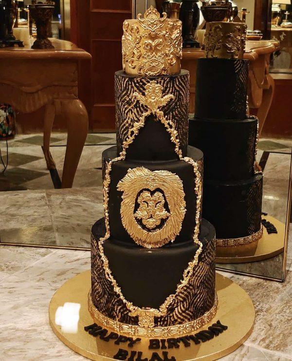 Royal 3-tier luxury black and gold cake with crown – perfect for husband’s birthday in Islamabad.