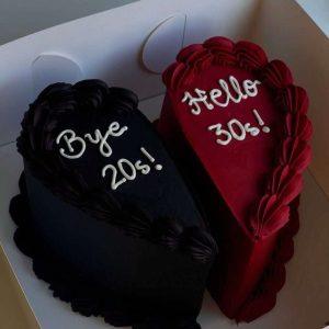 Red and black split heart-shaped fondant cake for couples – customized cake in Islamabad.